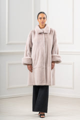 Full-length powder mink fur jacket with a wide fold-over collar, deep cuffs, and a horizontal seam separating the bodice and skirt.