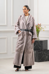 Silver blue mink fur coat with a wide lapel collar, belted waist, and hem panel. The fur is worked in a vertical orientation with large pockets.