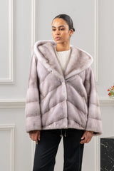 Silver blue mink fur short jacket with hood, featuring a V-chevron pattern on the body and wide, horizontally banded sleeves.