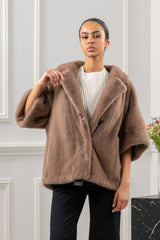 Taupe mink fur short jacket with a wide collar, three-quarter length sleeves, and a single front button closure.