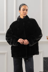 Short Blackglama mink jacket with a high collar, featuring chevron-patterned panels that point downward. The jacket has a relaxed, loose fit.
