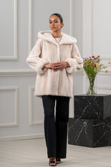 Pearl mink fur short jacket with a hood, featuring a relaxed fit, drop-shoulder sleeves with wide cuffs, and a concealed front closure.