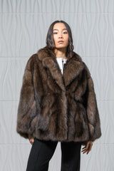 Short brown Russian sable jacket with a notched collar, wide sleeves, and a vertical panel construction in a straight-cut silhouette.