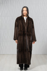 A brown mink fur coat with a smooth, vertical-pelts construction, a straight silhouette, and a simple collar, reaching calf-length.