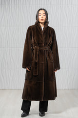 Brown mink fur coat featuring horizontal panel construction, a shawl collar, and a matching tie belt at the waist.