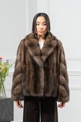 Brown Russian sable short jacket featuring a notched collar, long sleeves with a V chevron pattern, and a boxy fit against a white background.