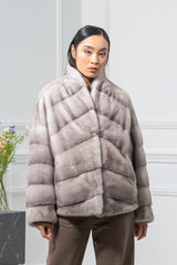 Silver blue mink fur jacket with a standing collar and front panels worked in a V chevron pattern, transitioning to horizontal rows on the sleeves.