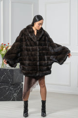 A short Russian sable jacket in a dark, rich brown with horizontal pelts, wide sleeves, and an oversized collar, worn open.
