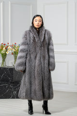 A blue frost fox fur coat with a wide collar, featuring horizontal fur panels on the sleeves and a solid, long-haired vertical construction body.