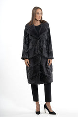 Swakara jacket in grey metal with a long hair fur collar. The body features diagonal panel construction and a straight, knee-length silhouette.