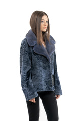 A blue metal Swakara jacket with wavy, textured fur panels and a large, smooth fur collar that extends down the front.