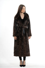 Long Swakara chocolate brown coat with a wide dark fur collar, featuring a tied waist belt, long sleeves, and a straight hemline.