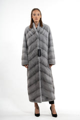 Full-length sapphire mink fur coat with a vertical chevron pattern meeting at the center seam, featuring a stand collar and long sleeves.