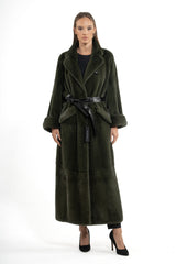 Full-length dark olive mink fur coat with vertical pelt orientation, featuring a wide lapel, cuffed sleeves, and a black leather tie belt.