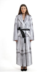 Long blackcross mink fur coat featuring a grid-like panel pattern, wide lapels, and a black leather waist tie over a long silhouette.