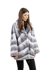 Short Blackcross mink fur jacket with an inverted V chevron pattern, wide notched collar, and a drawstring hem on black leggings.