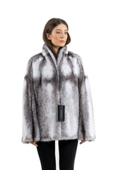 Short blackcross mink jacket with long-hair texture, featuring a stand-up collar, vertical panel construction, and a relaxed, straight-cut fit.