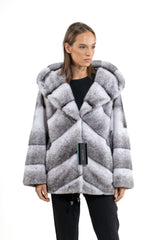 Front view of a Blackcross mink fur short jacket with a hood, featuring a V-chevron pattern in grey, white, and black.