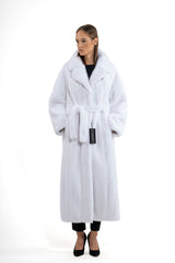 A long white mink coat featuring a wide collar, long sleeves, and a matching fur belt tied at the waist, worn over black trousers.