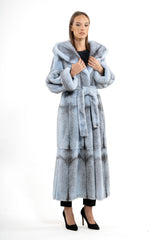 Baby blue mink long-hair coat with a tie waist, hood, and dark grey cross-patterned fur panels, ending at the mid-calf with side slits.
