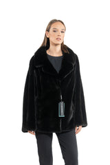 Front view of a Blackglama mink short jacket with a wide fold-over collar, straight fit, and long sleeves, showcasing a deep black uniform pelt.