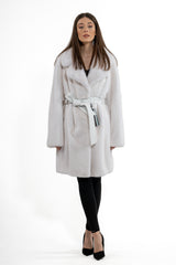 White mink fur jacket with a notched lapel collar and a white leather waist tie, featuring a vertical pelt construction, shown from the front.