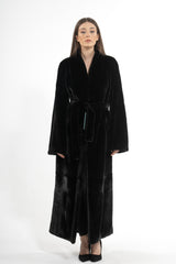 A long Blackglama mink fur coat with a shawl collar, wide sleeves, and a matching fur tie belt cinching the waist.