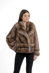 A Russian sable short jacket in a light brown hue, featuring a wide collar, vertical fur panels, and a horizontal banded design at the hem.