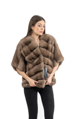 Russian sable short jacket with a front V chevron pattern, collarless design, and three-quarter length sleeves worn over black leggings.