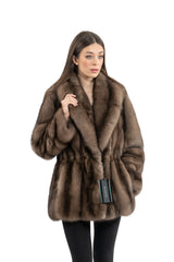 A short Russian sable jacket featuring a wide collar and a waist-cinched silhouette, with fur panels arranged in a vertical pattern.