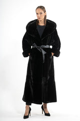 A long Blackglama mink fur coat featuring a large hood, wide lapels, and a black leather waist belt tied in front with deep side pockets.