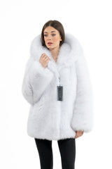 Short Shadow Blue Frost fox fur jacket with a large hood, long sleeves, and a MANZARI brand tag hanging from the front closure.