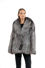 A short jacket made of long-haired silver natural fox fur with a wide, shawl-style collar and a straight fit.