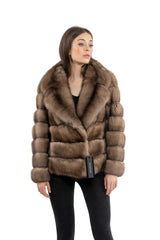 Russian sable short jacket featuring wide lapels, horizontal banded fur construction, and a black brand tag attached to the lower front hem.