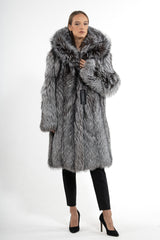 Silver natural fox fur jacket with a voluminous hood and long sleeves, showcasing a gradient of silver and charcoal tones in a straight silhouette.
