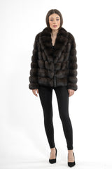 Short Russian sable jacket with horizontal fur panels, a notched collar, and a full-front button closure, shown on a model against a white background.