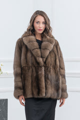 Russian sable short jacket featuring a wide shawl collar, vertical panels on the torso, and horizontal banded fur details on the sleeves.