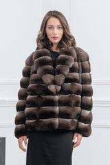 A burgundy chinchilla short jacket with horizontal fur panels, a round collar, and a boxy silhouette, shown from the front.