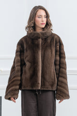 Front view of a brown mink fur jacket with a high collar, featuring sleeves designed with horizontal fur bands and a smooth, solid center.
