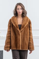 Gold mink fur jacket with wide lapels and horizontal panels on the sleeves, featuring a smooth central body and a short, straight-cut silhouette.