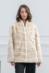 Cinnamon mink fur vest with a stand-up collar, featuring a horizontal and V-shaped chevron piecing pattern on a light, neutral-toned hide.