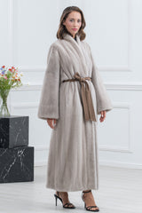 Pearl blue mink fur coat featuring a full-length, straight silhouette with a shawl collar, wide sleeves, and a brown suede tie-waist belt.