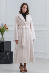Pearl mink fur coat in a full-length silhouette with a wide shawl collar, long sleeves, and a matching self-tie fur belt at the waist.
