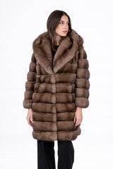 Front view of a Russian sable jacket with a large hood and horizontal fur panels, finished in a warm brown tone.