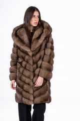A lavender Russian sable jacket with a hood, featuring a V-chevron pattern, long sleeves, and a mid-thigh length silhouette.