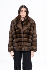 A short brown Russian sable jacket with a folded collar and horizontal fur panels on the sleeves and body.