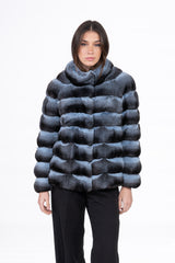 Front view of a short chinchilla jacket featuring horizontal panels of dark grey and light blue fur, with a high stand-up collar.