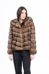 Russian sable short jacket with a hood, featuring horizontal fur panels arranged in a V-chevron pattern on the body, on a white background.
