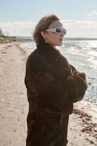 Manzari Chokolat Swakara fur coat for a luxurious feel