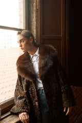 Chocolate brown Swakara coat with a large, plush brown sable fur collar and wide sleeves, worn open over a light blue collared shirt.